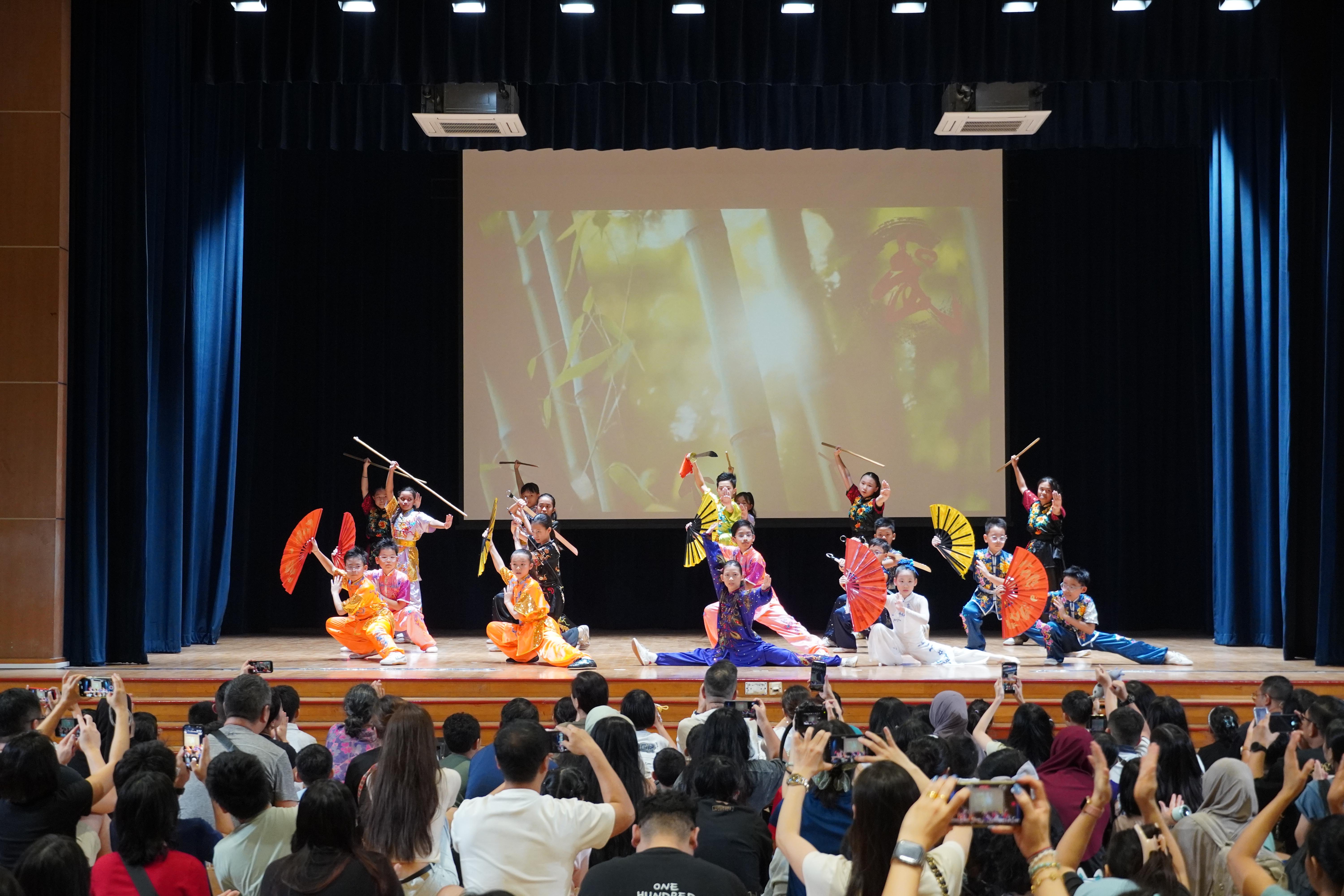 Fans, martial arts and striking poses come together in a colourful performance that keeps the audience captivated.